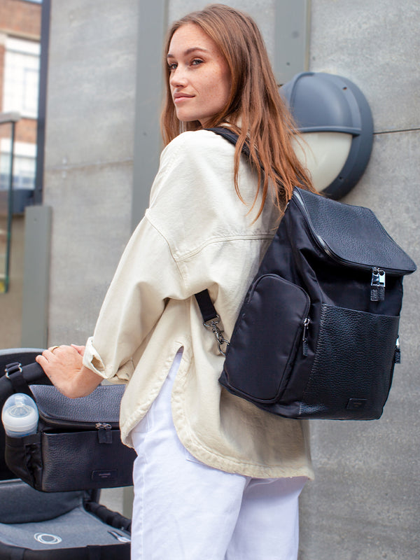 Storksak Alyssa Bundle Discount - Special Offer mum wearing Backpack with Stroller bag attached to pram