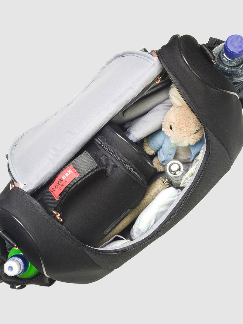 storksak poppy luxe scuba black, convertible changing bag, inside view with baby items inside