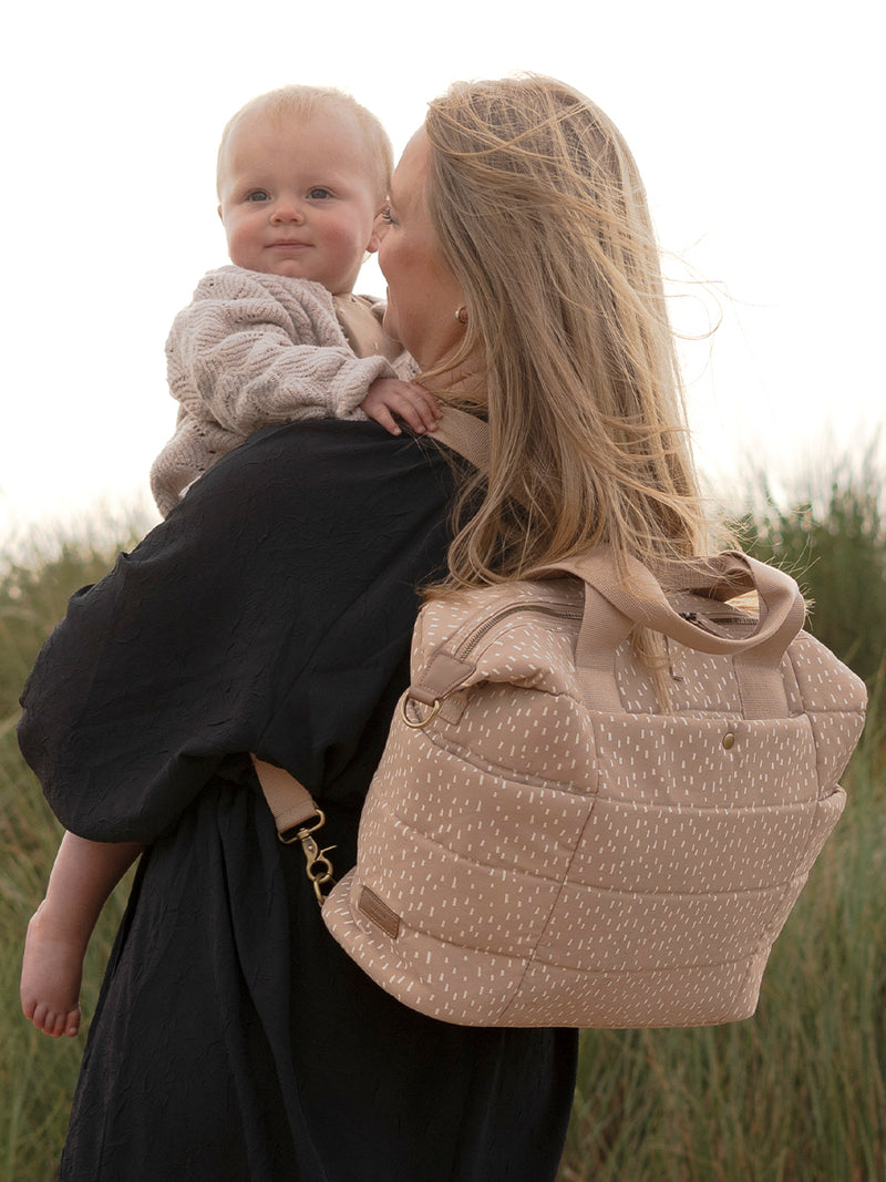 storksak organic cotton changing bag, mum wearing as backpack, holding baby
