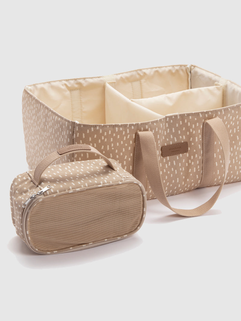 Storksak organic nappy caddy seashell | angled view showing accede and zipped pouch