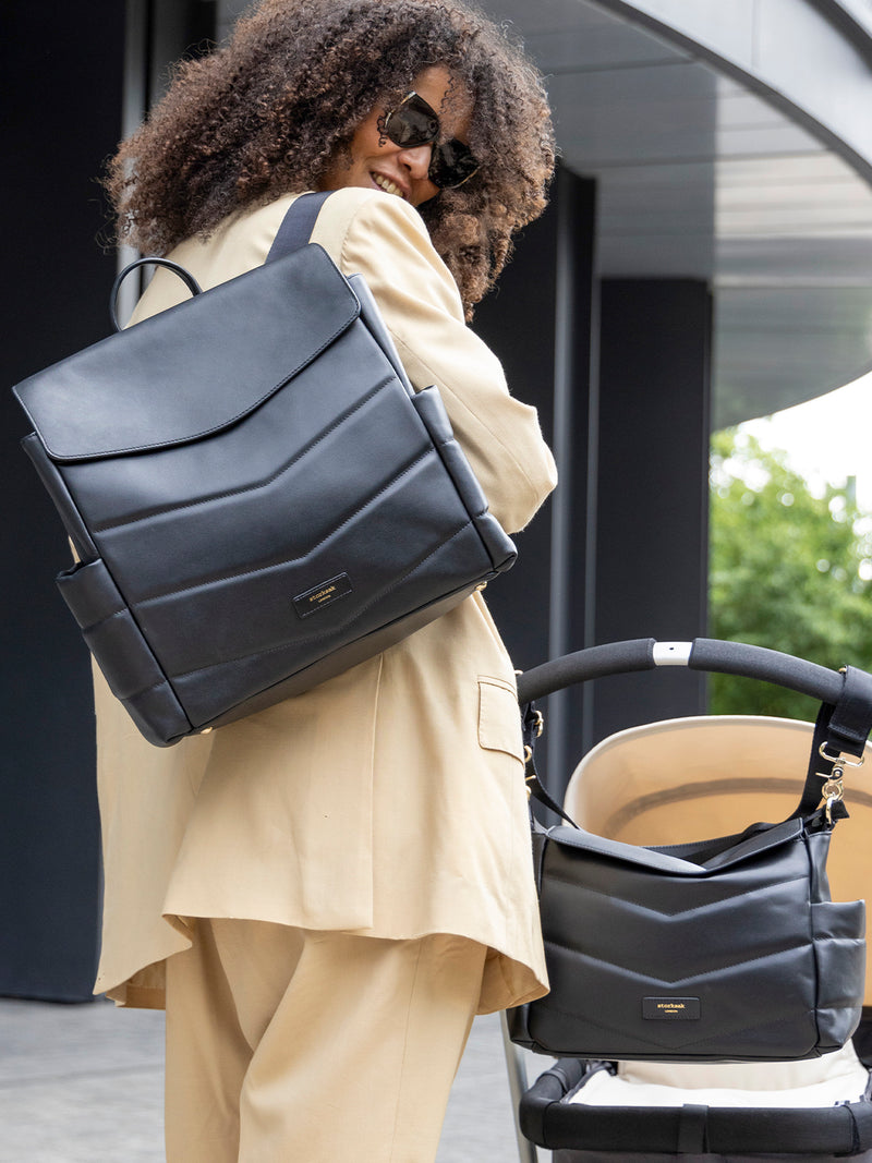 Storksak st james leather quilt black | mum wearing bag as backpack