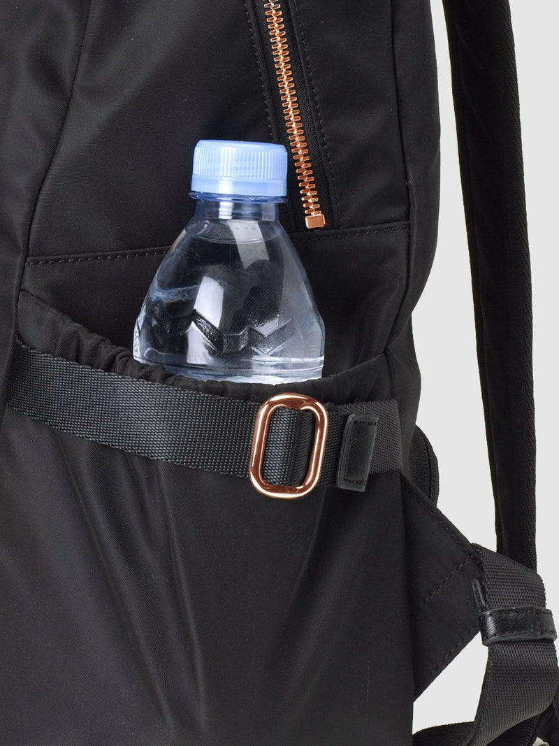 storksak hero quilt black, changing bag backpack, in quilted nylon with rose gold hardware, side view of bottle pocket