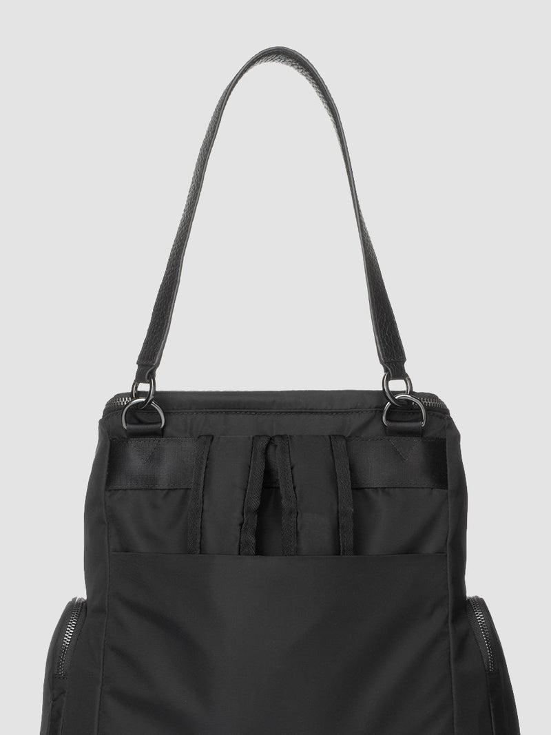 Storksak Alyssa | convertible Changing bag Backpack | Leather Baby Bag | Black diaper Bag back view of leather shoulder strap