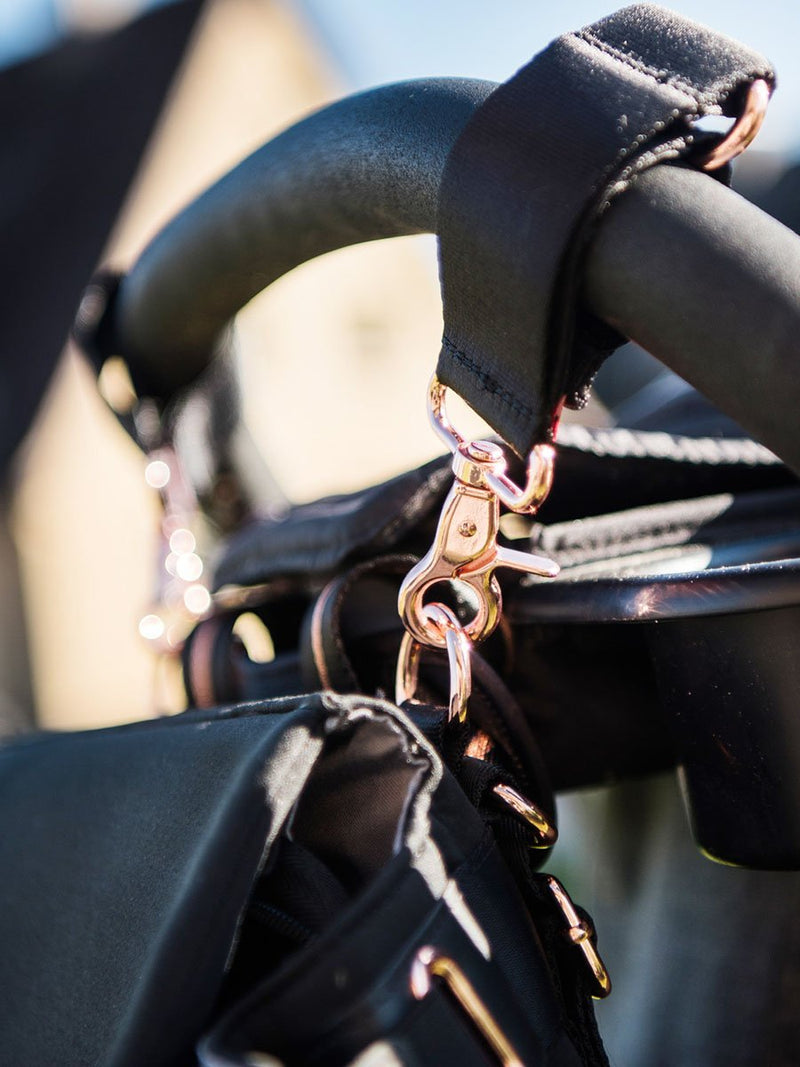 storksak st james scuba black, convertible changing bag, close up for rose gold hardware on stroller clips