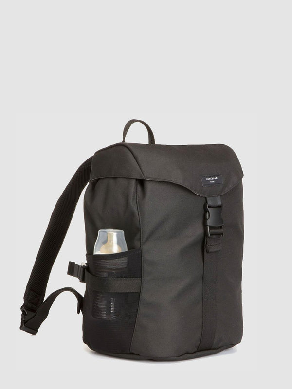 storksak travel eco backpack black, changing bag rucksack, recycled material, front view with baby bottle in side pocket