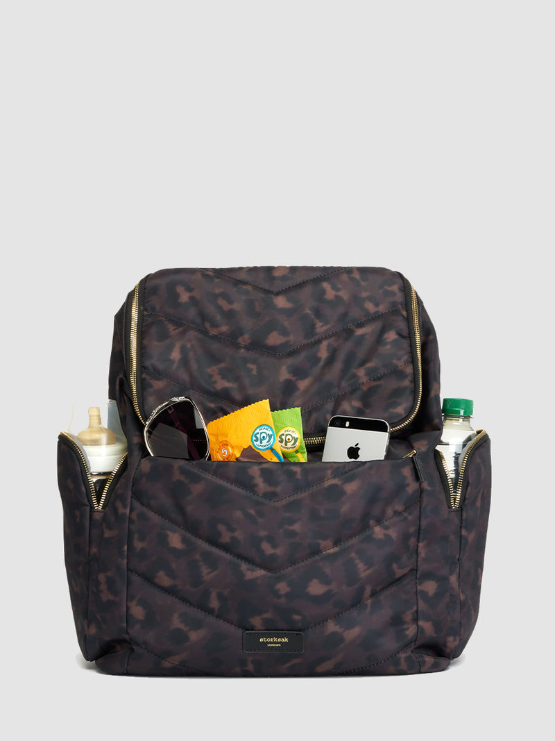 storksak alyssa leopard changing bag with baby items in the pockets